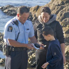 Fishery Officer measuring paua