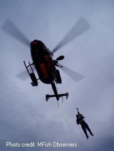 Helicopter airlifting fisherman